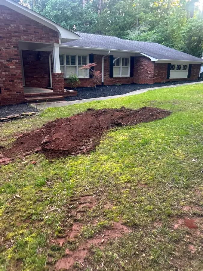 New foundation mulch beds along the front of a brick ranch home
